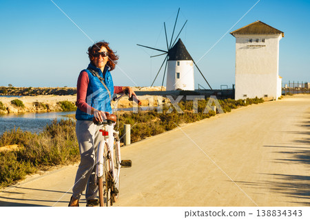 Woman with bike at San Pedro del Pinatar park, Spain Woman with bike at San Pedro del Pinatar park, Spain 138834343