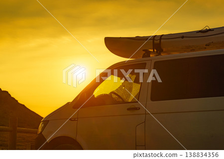 Car with canoe on top roof at sunset Car with canoe on top roof at sunset 138834356
