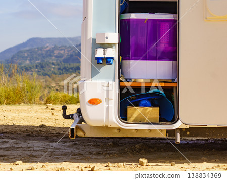 Rv camper camping on nature, open door storage.. Rv camper camping on nature, open door storage.. 138834369