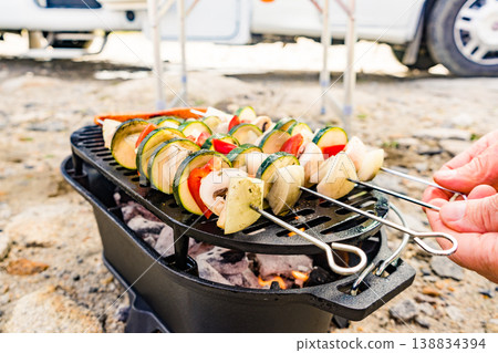 Grilled vegetables on barbecue grill. Rv in the distance Grilled vegetables on barbecue grill. Rv in the distance 138834394