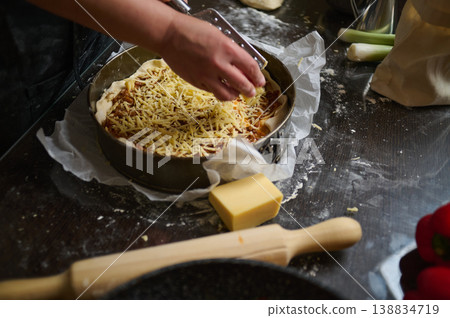Final cheese topping added to homemade lasagna before baking Final cheese topping added to homemade lasagna before baking 138834719