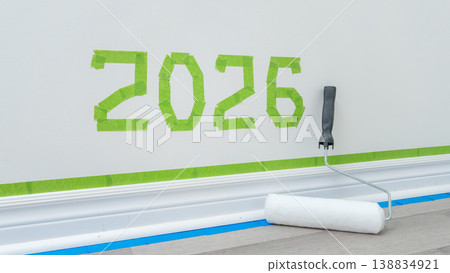 Wall painting project with green tape forming the number 2026 and a paint roller resting on the floor in a modern interior setting Wall painting project with green tape forming the number 2026 and a paint roller resting on the floor in a modern interior setting 138834921