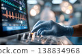 Medical professional adjusts monitor settings in operating room, displaying heart rate and vital signs during surgical procedure 138834968