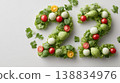 Fresh vegetables arranged to form the number 22, featuring lettuce, tomatoes, and herbs on a light background 138834976