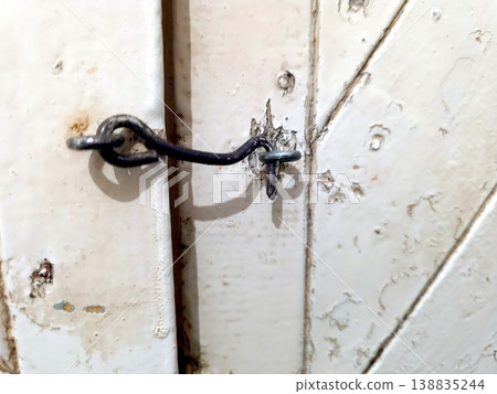 Door Hook on a Wooden Door Shows Wear and Tear From Years of Use and Aging Door Hook on a Wooden Door Shows Wear and Tear From Years of Use and Aging 138835244