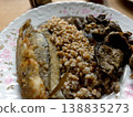 Fried Fish With Buckwheat and Mushrooms on a Plate Served in a Cozy Dining Space 138835273