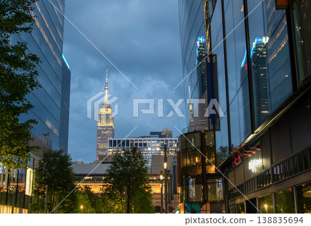 New york, usa august 15,2024. Empire state building rising above manhattan streets at twilight, illuminated skyscraper and bustling urban skyline in new york city New york, usa august 15,2024. Empire state building rising above manhattan streets at twilight, illuminated skyscraper and bustling urban skyline in new york city 138835694