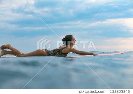 Gentle Sea Environment As Woman Practices Mindful Paddleboarding Techniques 138835846