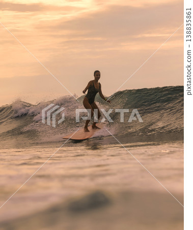 Skilled Surf Coach Performing Sharp Maneuvers In Golden Evening Light Skilled Surf Coach Performing Sharp Maneuvers In Golden Evening Light 138835861