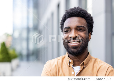 Young man with a warm smile looking away, expressing happiness and confidence while standing outdoors in a modern city environment, conveying professionalism and success Young man with a warm smile looking away, expressing happiness and confidence while standing outdoors in a modern city environment, conveying professionalism and success 138835902