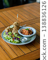 Western Style Fried Chicken with Pasta and Salad on Wooden Table 138836126