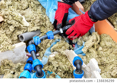 Plumber moving compression ring of compression fitting for HDPE pipes along pipe. 138836299