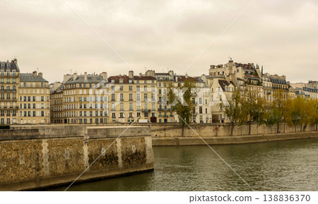 Iconic Haussmann buildings lining Seine River banks in Paris, France, reflecting European urban travel and architecture Iconic Haussmann buildings lining Seine River banks in Paris, France, reflecting European urban travel and architecture 138836370