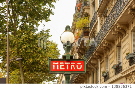 Paris Metro sign with classic Haussmann building, capturing city travel, architecture, and urban landmark Paris Metro sign with classic Haussmann building, capturing city travel, architecture, and urban landmark 138836371