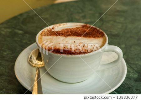 Paris cafe culture with a warming cappuccino on a green marble table, enjoying French travel and morning breakfast Paris cafe culture with a warming cappuccino on a green marble table, enjoying French travel and morning breakfast 138836377