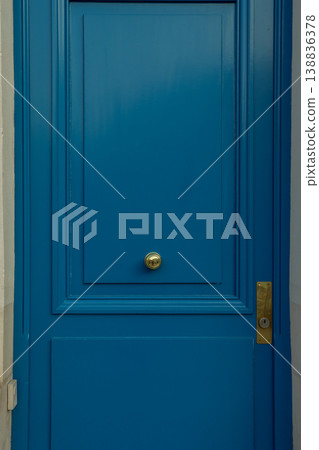 Parisian street with vibrant blue door and brass doorknob, classic French architecture welcoming guests Parisian street with vibrant blue door and brass doorknob, classic French architecture welcoming guests 138836378
