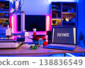 A modern 3D printing setup with a laptop displaying the word HOME, filament spools, and a small 3D printed object 138836549