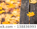 Yellow autumn leaves on wooden table in cozy atmosphere 138836993