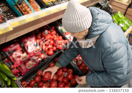 Senior woman shopping in modern supermarket during winter Senior woman shopping in modern supermarket during winter 138837150