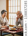 An elderly couple having a conversation in a Japanese-style room. 138837285