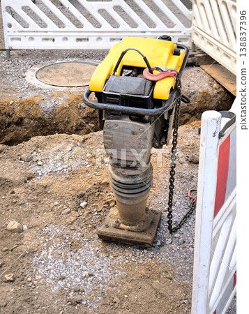 Vibratory rammer at a construction site for soil compaction Vibratory rammer at a construction site for soil compaction 138837396