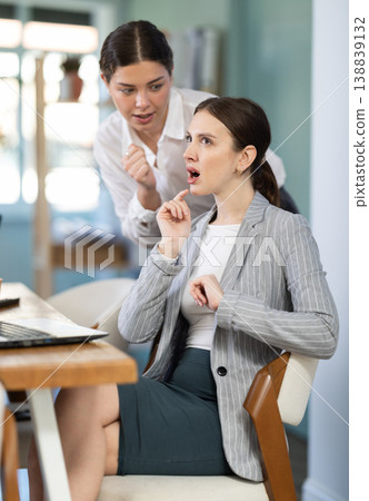 women gossip about colleagues in the office women gossip about colleagues in the office 138839132