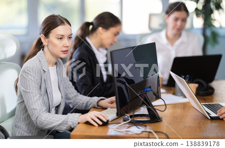 Young woman is a qualified specialist, works in a modern office Young woman is a qualified specialist, works in a modern office 138839178