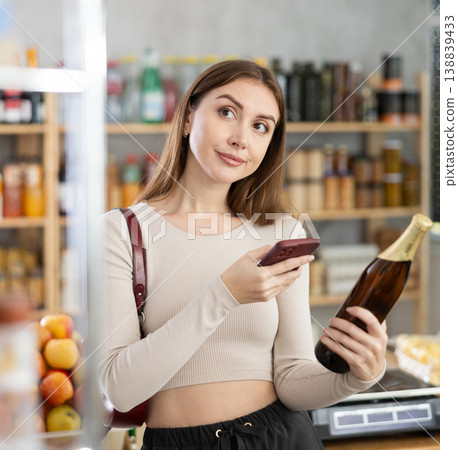 Young woman scanning qr code of beer Young woman scanning qr code of beer 138839433