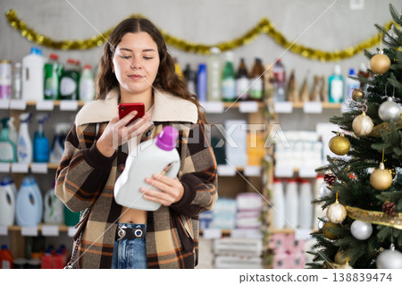 Young woman scanning qr code for detergent 138839474