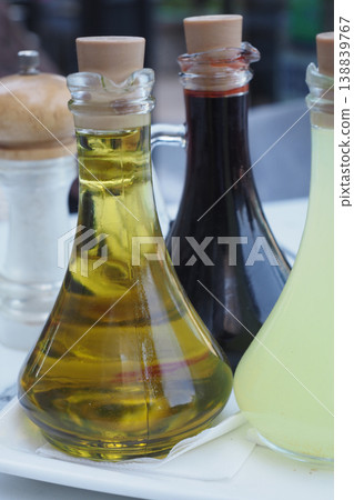Olive oil, balsamic vinegar, and lemon juice on table 138839767