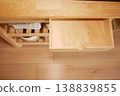 Wooden drawer in a kitchen cabinet is partially open 138839855