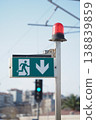 Emergency exit sign shown during the day 138839859