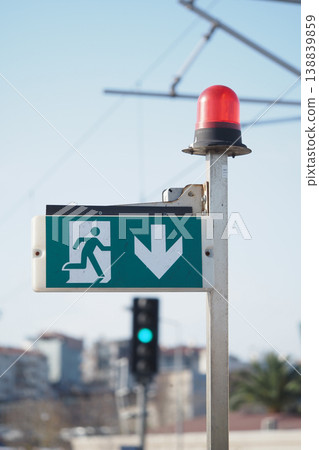 Emergency exit sign shown during the day 138839859