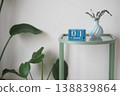 Table displays calendar and vase with plant on January first 138839864
