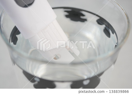 Handheld Water Quality Tester Probe in Glass Of Clear Water For Home And Laboratory Testing 138839866