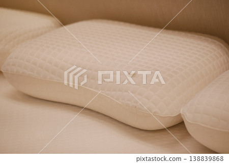 orthopedic pillows arranged on a bed during the day 138839868