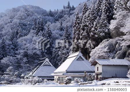 A snowy morning in winter; a mountain village landscape in winter; fresh snow piled on trees and houses. A snowy morning in winter; a mountain village landscape in winter; fresh snow piled on trees and houses. 138840003