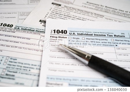 Tax Return form 1040 with pencil, U.S. Individual Income. 138840030