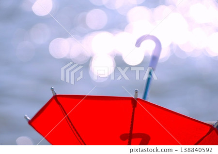 Red umbrella & bokeh on the shore Red umbrella & bokeh on the shore 138840592