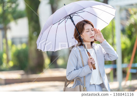 Business woman pointing a parasol 138841116