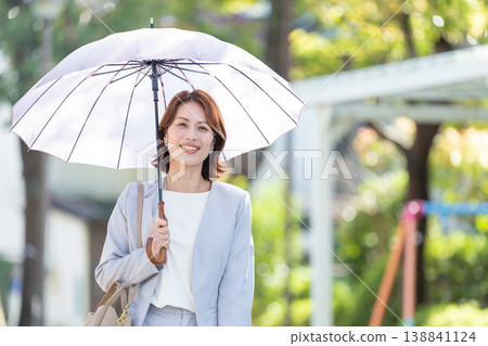 Business woman pointing a parasol 138841124