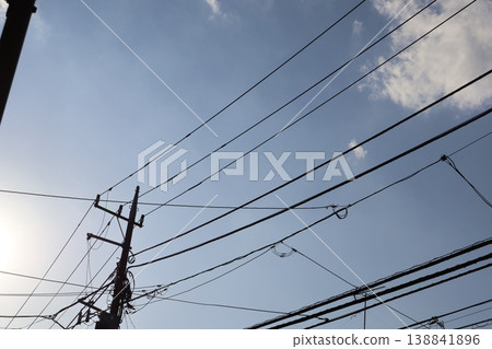 The quiet streets in the afternoon, with the shadows of the utility poles stretching long. 138841896