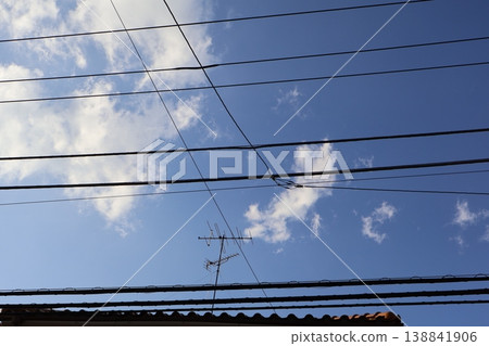 A utility pole standing in a narrow alley and a cracked asphalt wall 4 A utility pole standing in a narrow alley and a cracked asphalt wall 4 138841906