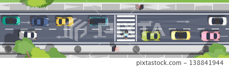 Above view of many cars are stopped at the red light indicating a pedestrian crossing. People are crossing the street at the crosswalk for safety. Sidewalks and trees along the side of the road. Above view of many cars are stopped at the red light indicating a pedestrian crossing. People are crossing the street at the crosswalk for safety. Sidewalks and trees along the side of the road. 138841944