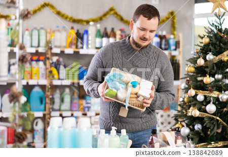 Interested nice bearded man choosing gifts for New Year in household department of supermarket 138842089