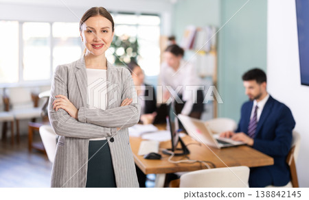 Young woman welcoming clients at workplace 138842145