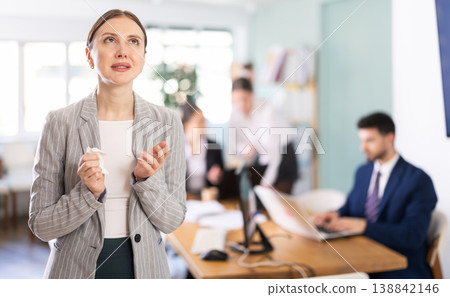 Upset woman stands in the middle of the office Upset woman stands in the middle of the office 138842146