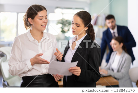 Two qualified female employees discussing work tasks Two qualified female employees discussing work tasks 138842170