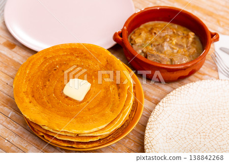 Belarusian machanka with assorted meat served with pancakes Belarusian machanka with assorted meat served with pancakes 138842268