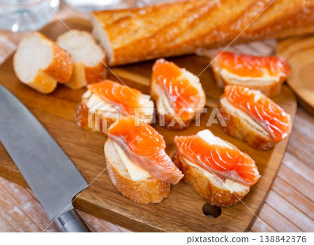 Sandwiches with butter and salted salmon on wooden board Sandwiches with butter and salted salmon on wooden board 138842376